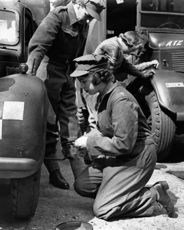 Princess Elizabeth changes car wheel during her training in Auxiliary Territorial Service May 6, 1945.